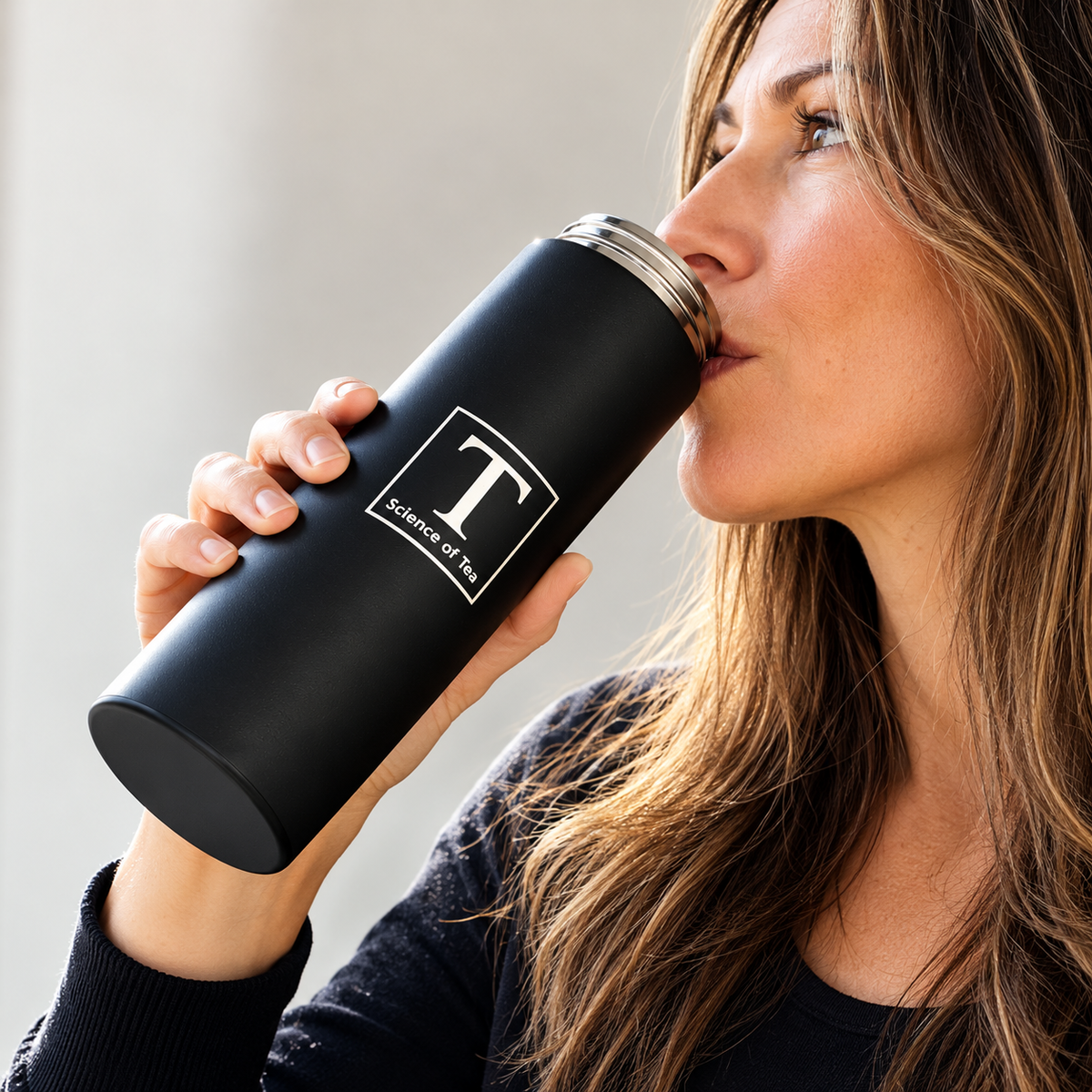 Woman drinking directly from an open Science of Tea TUMBLER